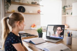 Tips & Tricks for Teaching Young girl talks to her teacher via Zoom video app