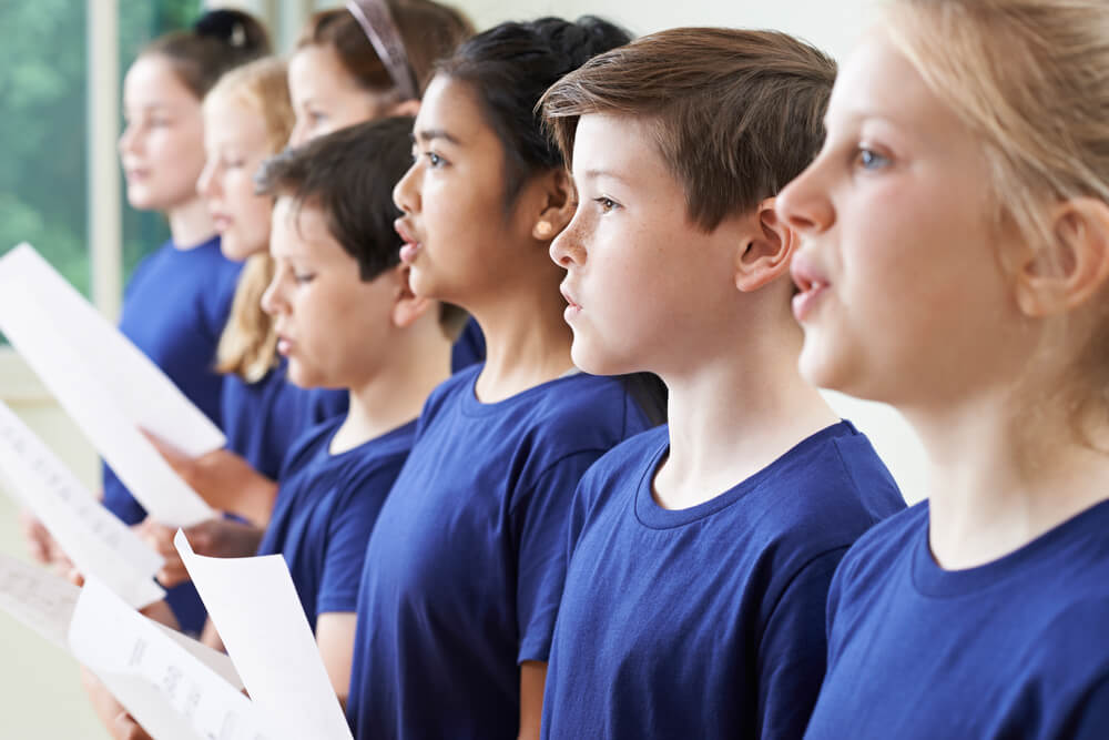 group of school children singing in choir together