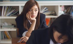 Upset asian girl in classroom
