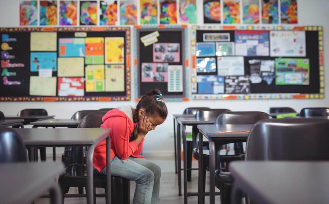 girl sitting in classroom chair