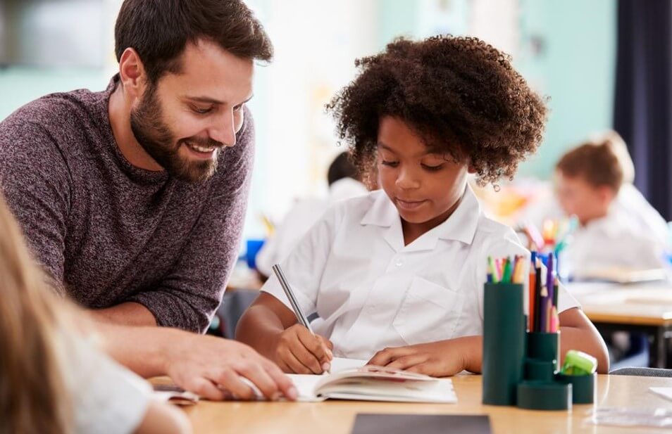 male elementary teacher with student