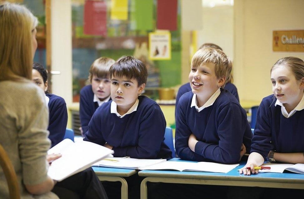 students looking at teacher