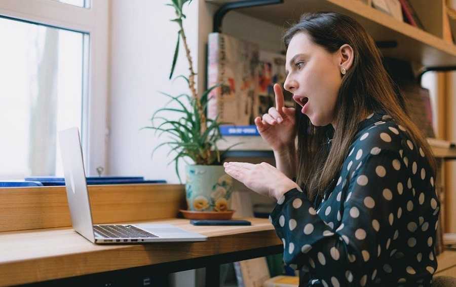 women practicing sign language on laptop