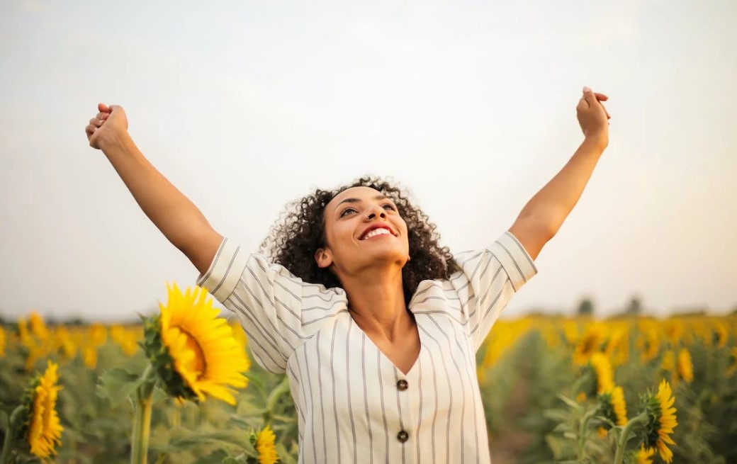 happy women in sunflower field