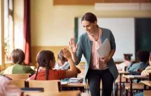 Teacher hi five with student Teacher hi five with student